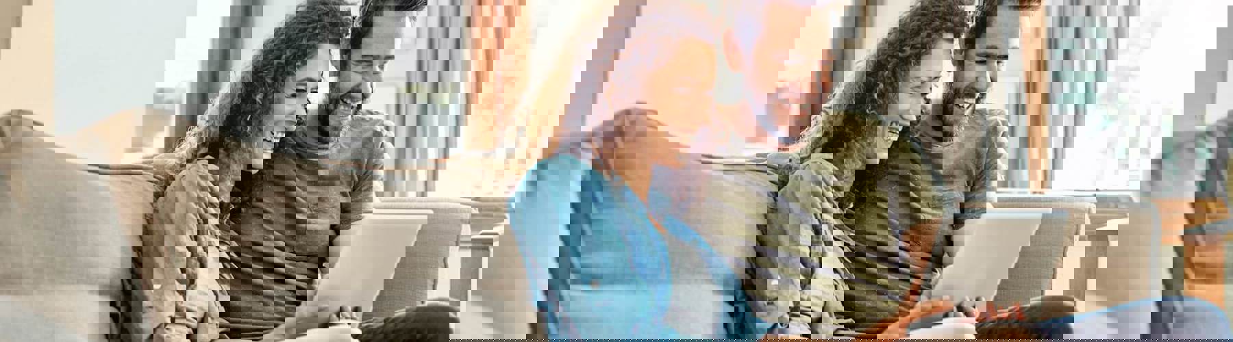 Couple on couch with tablet